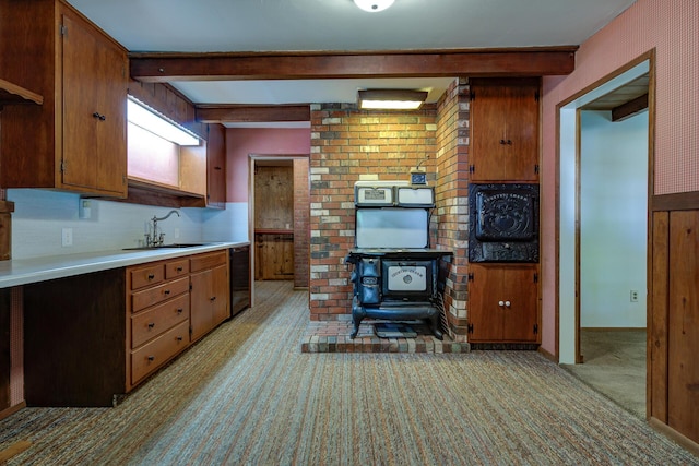 2915 Rockabye Ln, Redding, CA 96002 - kitchen featuring a sink, light colored carpet, beamed ceiling, light countertops, and a wood stove