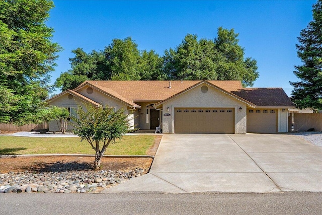 17935 Arlington Ct, Anderson, CA 96007 - ranch-style home with an attached garage, driveway, and stucco siding