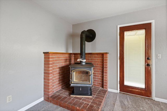2190 Skyline Dr, Redding, CA 96001 - detailed view of a wood stove, baseboards, and carpet flooring