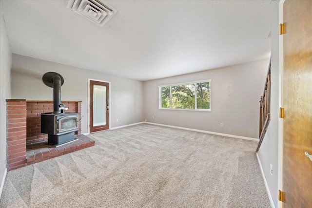 2190 Skyline Dr, Redding, CA 96001 - unfurnished living room with a wood stove, carpet flooring, and baseboards