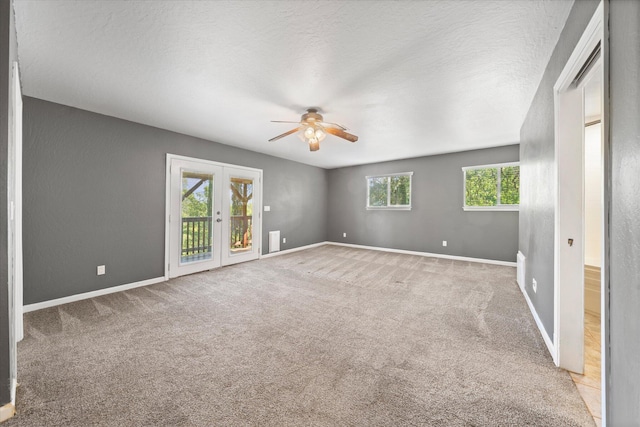 2190 Skyline Dr, Redding, CA 96001 - carpeted spare room with a ceiling fan, french doors, baseboards, and a textured ceiling