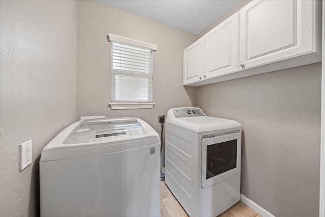 2190 Skyline Dr, Redding, CA 96001 - laundry area with washing machine and clothes dryer, cabinet space, and light tile patterned flooring