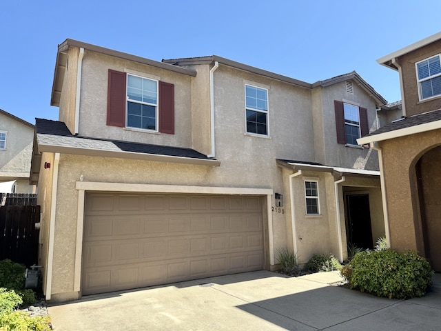2135 Vienna Way, Redding, CA 96003 - view of property with stucco siding, a garage, and driveway