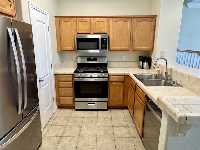 2135 Vienna Way, Redding, CA 96003 - kitchen with appliances with stainless steel finishes, a sink, tile countertops, and a peninsula