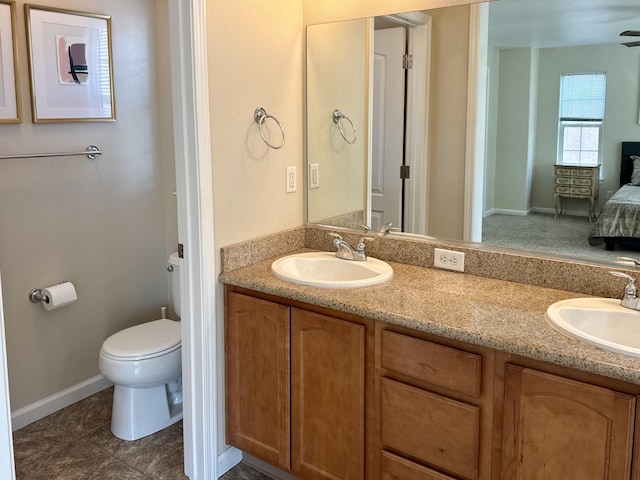 2135 Vienna Way, Redding, CA 96003 - ensuite bathroom with double vanity, toilet, and baseboards