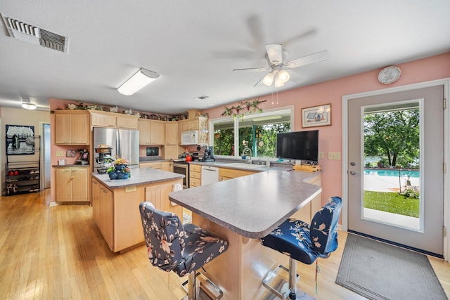 2940 Felstet Ln, Redding, CA 96001 - kitchen featuring appliances with stainless steel finishes, light brown cabinets, healthy amount of natural light, and ceiling fan