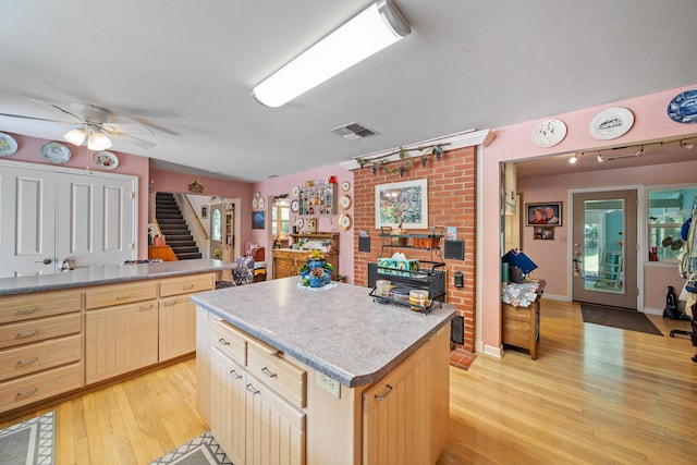 2940 Felstet Ln, Redding, CA 96001 - kitchen with light wood-style floors, ceiling fan, light brown cabinets, a center island, and rail lighting
