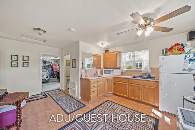 2940 Felstet Ln, Redding, CA 96001 - kitchen with white appliances, light countertops, ceiling fan, decorative backsplash, and a textured ceiling