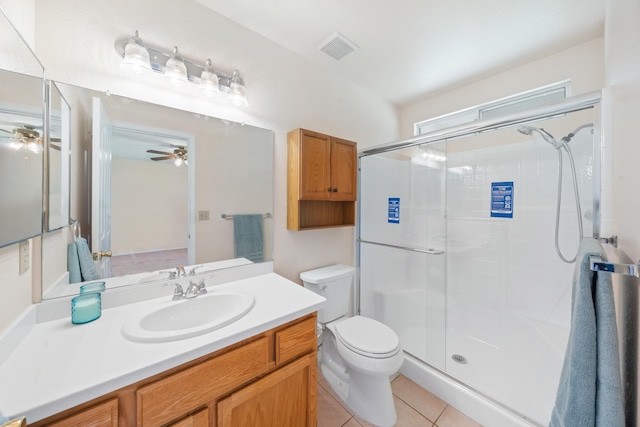 1626 French Lace Ln, Redding, CA 96003 - bathroom featuring ceiling fan, toilet, a stall shower, vanity, and tile patterned floors