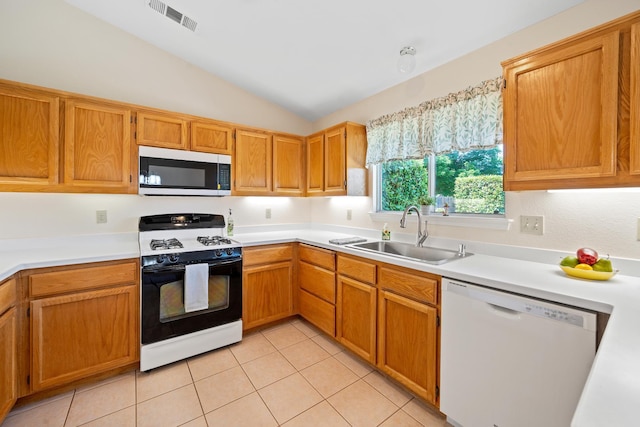 1626 French Lace Ln, Redding, CA 96003 - kitchen with stainless steel microwave, white dishwasher, range with gas stovetop, a sink, and lofted ceiling