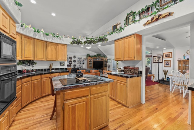 15947 Butterfield Ln, Anderson, CA 96007 - kitchen featuring black appliances, light wood-style flooring, a center island, recessed lighting, and tile countertops