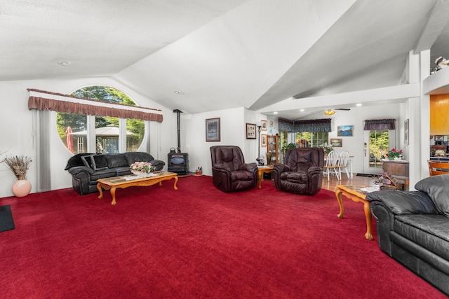 15947 Butterfield Ln, Anderson, CA 96007 - living room featuring a wood stove, lofted ceiling, and carpet floors
