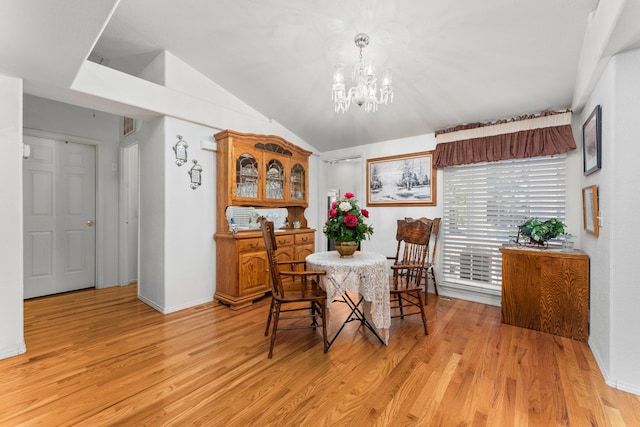 15947 Butterfield Ln, Anderson, CA 96007 - dining room featuring light wood-style flooring, vaulted ceiling, a chandelier, and baseboards