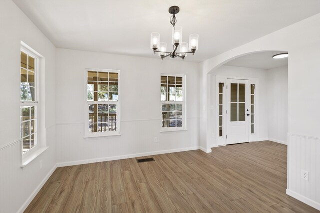 13360 Oak Run Rd, Oak Run, CA 96069 - unfurnished dining area featuring wood finished floors, a chandelier, and plenty of natural light