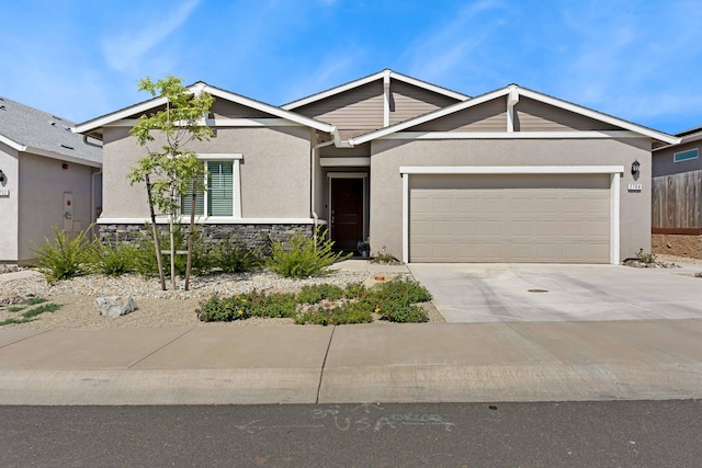 2764 Austere Ave, Redding, CA 96003 - view of front of property with stucco siding, an attached garage, concrete driveway, and stone siding