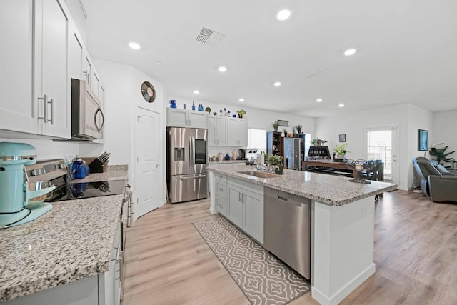 2764 Austere Ave, Redding, CA 96003 - kitchen featuring appliances with stainless steel finishes, a sink, light wood-type flooring, a center island, and open floor plan