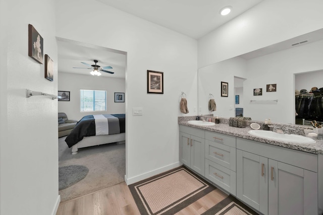2764 Austere Ave, Redding, CA 96003 - bathroom featuring wood finished floors, double vanity, connected bathroom, a ceiling fan, and baseboards