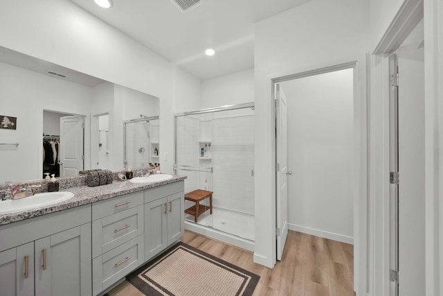 2764 Austere Ave, Redding, CA 96003 - bathroom with a walk in closet, a shower stall, wood finished floors, double vanity, and recessed lighting