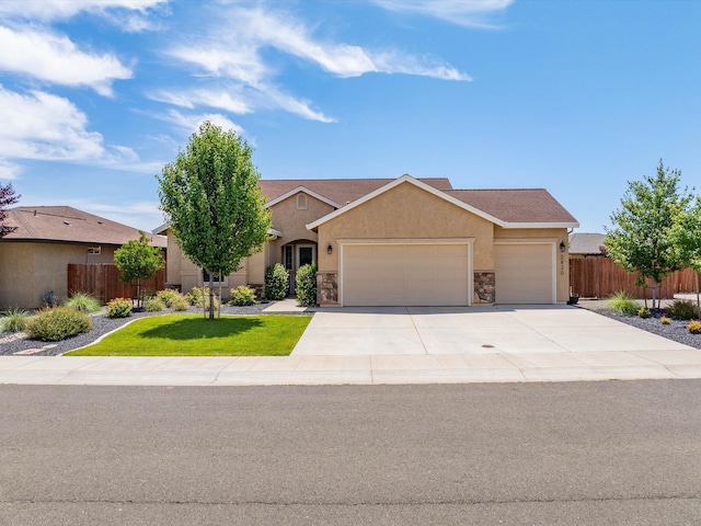 2830 Calaveras Ct, Redding, CA 96002 - view of front of house featuring a garage, concrete driveway, stucco siding, and stone siding