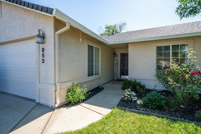 853 Paramount Way, Redding, CA 96003 - property entrance with stucco siding and an attached garage