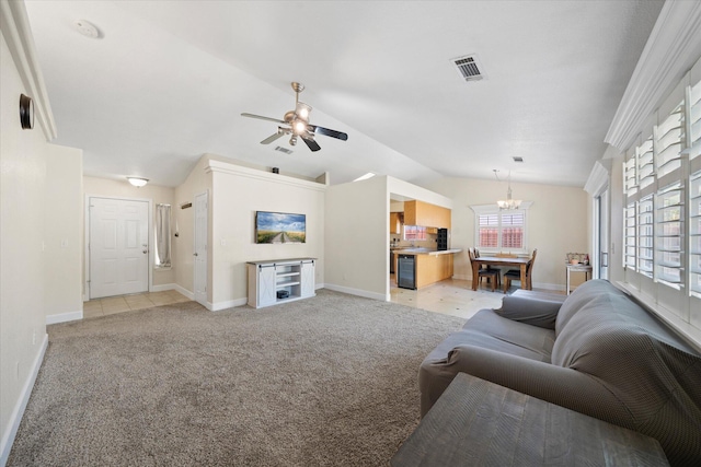 853 Paramount Way, Redding, CA 96003 - living room with vaulted ceiling, a chandelier, light colored carpet, a ceiling fan, and baseboards