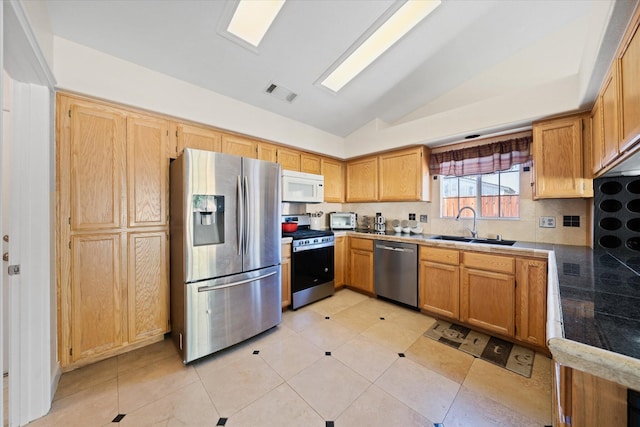 853 Paramount Way, Redding, CA 96003 - kitchen with stainless steel appliances, lofted ceiling, tasteful backsplash, a sink, and light tile patterned floors