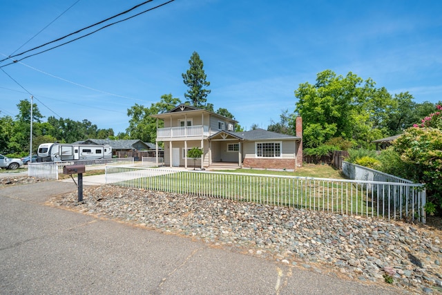 5101 Bidwell Rd, Redding, CA 96001 - view of front facade with a balcony, brick siding, driveway, and a chimney