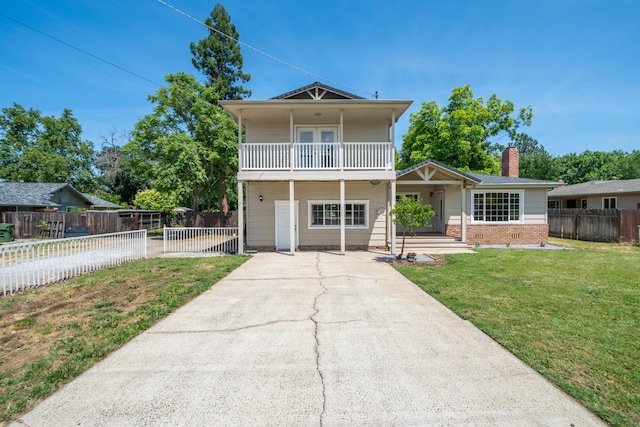 5101 Bidwell Rd, Redding, CA 96001 - view of front facade with a balcony, a porch, brick siding, a chimney, and concrete driveway