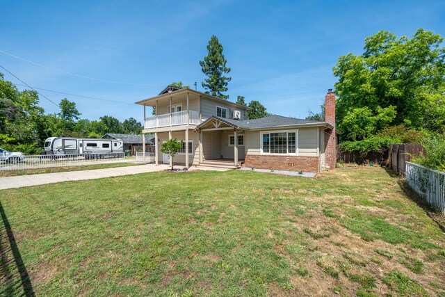 5101 Bidwell Rd, Redding, CA 96001 - view of front of home featuring a balcony, driveway, a chimney, and brick siding