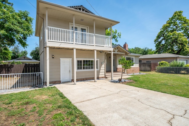 5101 Bidwell Rd, Redding, CA 96001 - view of front of property with a balcony, a chimney, and brick siding