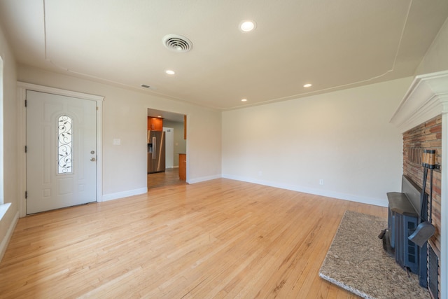 5101 Bidwell Rd, Redding, CA 96001 - unfurnished living room featuring light wood-style floors, baseboards, recessed lighting, and a fireplace with raised hearth