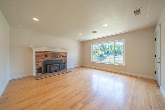 5101 Bidwell Rd, Redding, CA 96001 - unfurnished living room with wood finished floors, baseboards, recessed lighting, and a wood stove