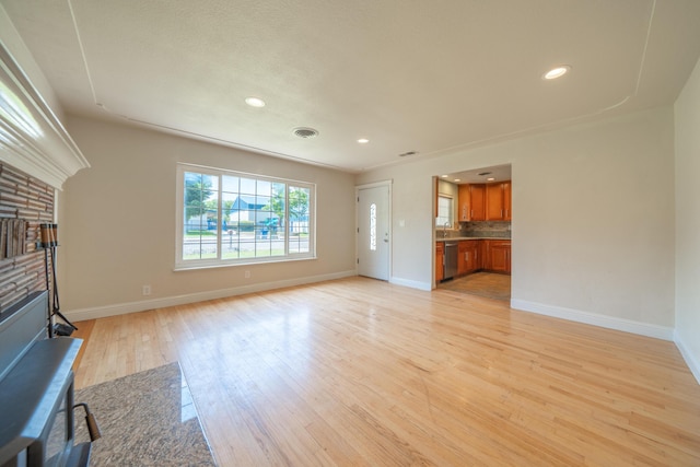 5101 Bidwell Rd, Redding, CA 96001 - unfurnished living room featuring light wood-type flooring, baseboards, recessed lighting, a sink, and a fireplace