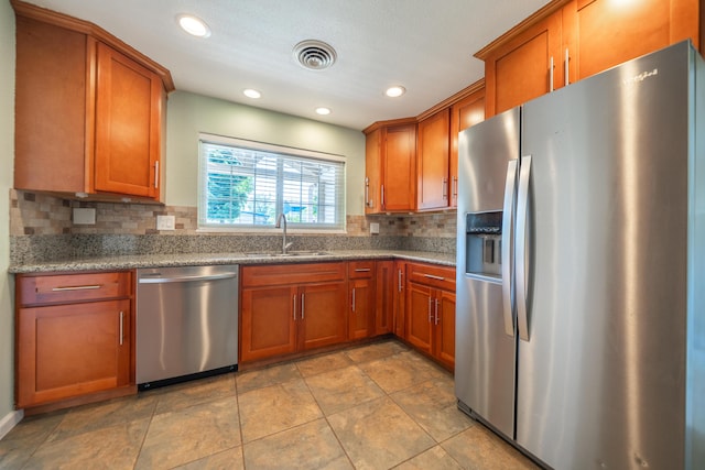5101 Bidwell Rd, Redding, CA 96001 - kitchen with stainless steel appliances, a sink, brown cabinets, tasteful backsplash, and recessed lighting