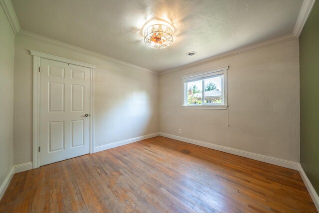 5101 Bidwell Rd, Redding, CA 96001 - unfurnished room featuring wood-type flooring, baseboards, and crown molding