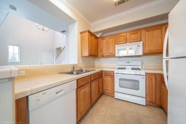 2340 Shining Star Way, Redding, CA 96003 - kitchen with white appliances, a sink, crown molding, light tile patterned floors, and a chandelier