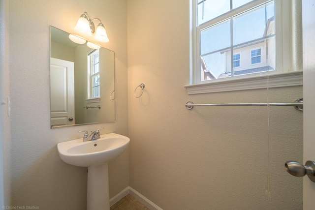 2340 Shining Star Way, Redding, CA 96003 - bathroom featuring plenty of natural light, baseboards, and a sink
