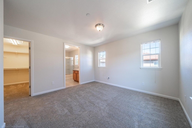 2340 Shining Star Way, Redding, CA 96003 - unfurnished bedroom featuring light colored carpet, a spacious closet, and baseboards