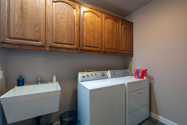 24943 Cox Ln, Los Molinos, CA 96055 - laundry area featuring independent washer and dryer, cabinet space, and baseboards