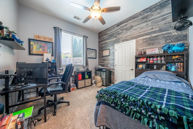 1030 Tulare Ct, Redding, CA 96003 - carpeted bedroom with wood walls, an accent wall, a desk, and ceiling fan