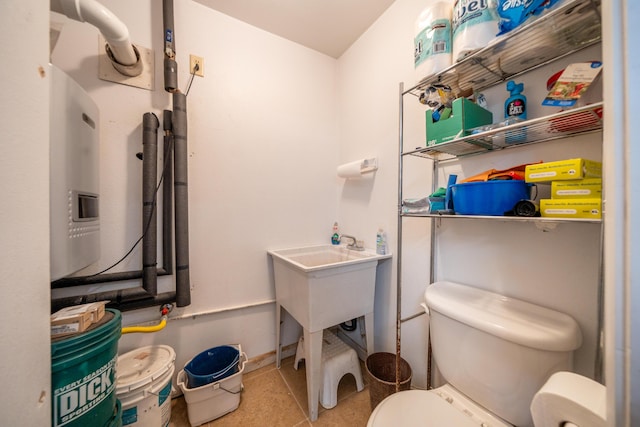 1030 Tulare Ct, Redding, CA 96003 - half bathroom with toilet, a sink, and baseboards