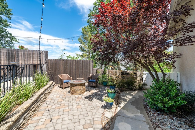 1030 Tulare Ct, Redding, CA 96003 - fenced backyard featuring a fire pit and a patio area