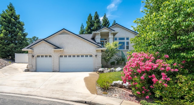 1030 Tulare Ct, Redding, CA 96003 - view of front of home featuring a garage, concrete driveway, and stucco siding