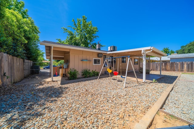 2006 Vale Dr, Redding, CA 96002 - rear view of house featuring a playground, board and batten siding, and a gate