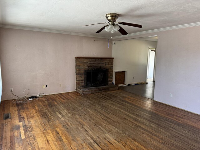 2392 Balls Ferry Rd, Anderson, CA 96007 - unfurnished living room featuring a ceiling fan, wood-type flooring, a fireplace, and ornamental molding
