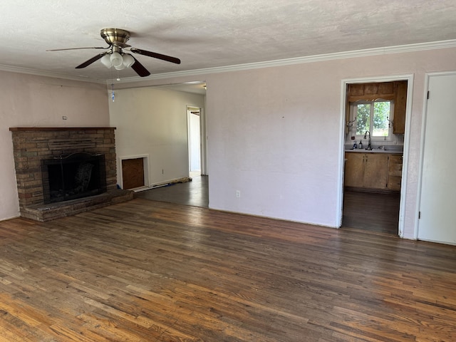 2392 Balls Ferry Rd, Anderson, CA 96007 - unfurnished living room with a sink, wood finished floors, ceiling fan, a fireplace, and crown molding
