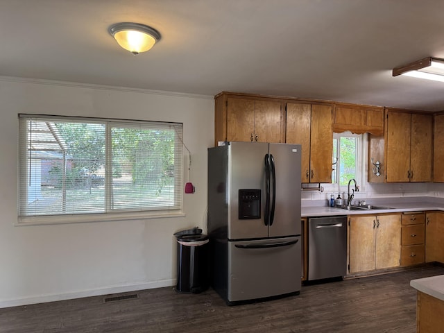 2392 Balls Ferry Rd, Anderson, CA 96007 - kitchen with stainless steel appliances, a sink, brown cabinetry, dark wood-type flooring, and crown molding