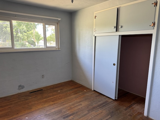 2392 Balls Ferry Rd, Anderson, CA 96007 - unfurnished bedroom featuring dark wood-style floors and a closet
