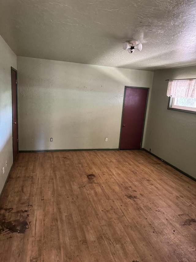 2392 Balls Ferry Rd, Anderson, CA 96007 - empty room featuring hardwood / wood-style flooring and a textured ceiling