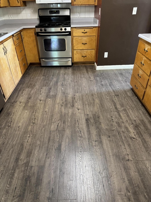 2392 Balls Ferry Rd, Anderson, CA 96007 - kitchen featuring gas stove, dark wood finished floors, light countertops, tasteful backsplash, and brown cabinets